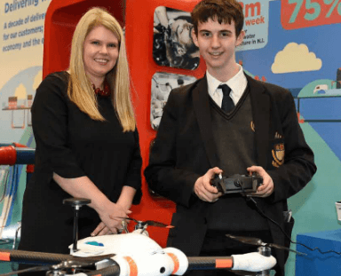 NI Water CEO showing drone technology to a student at Exhibition