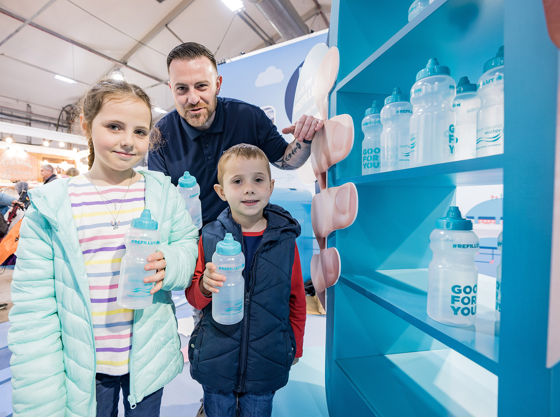 Two children holding water bottles