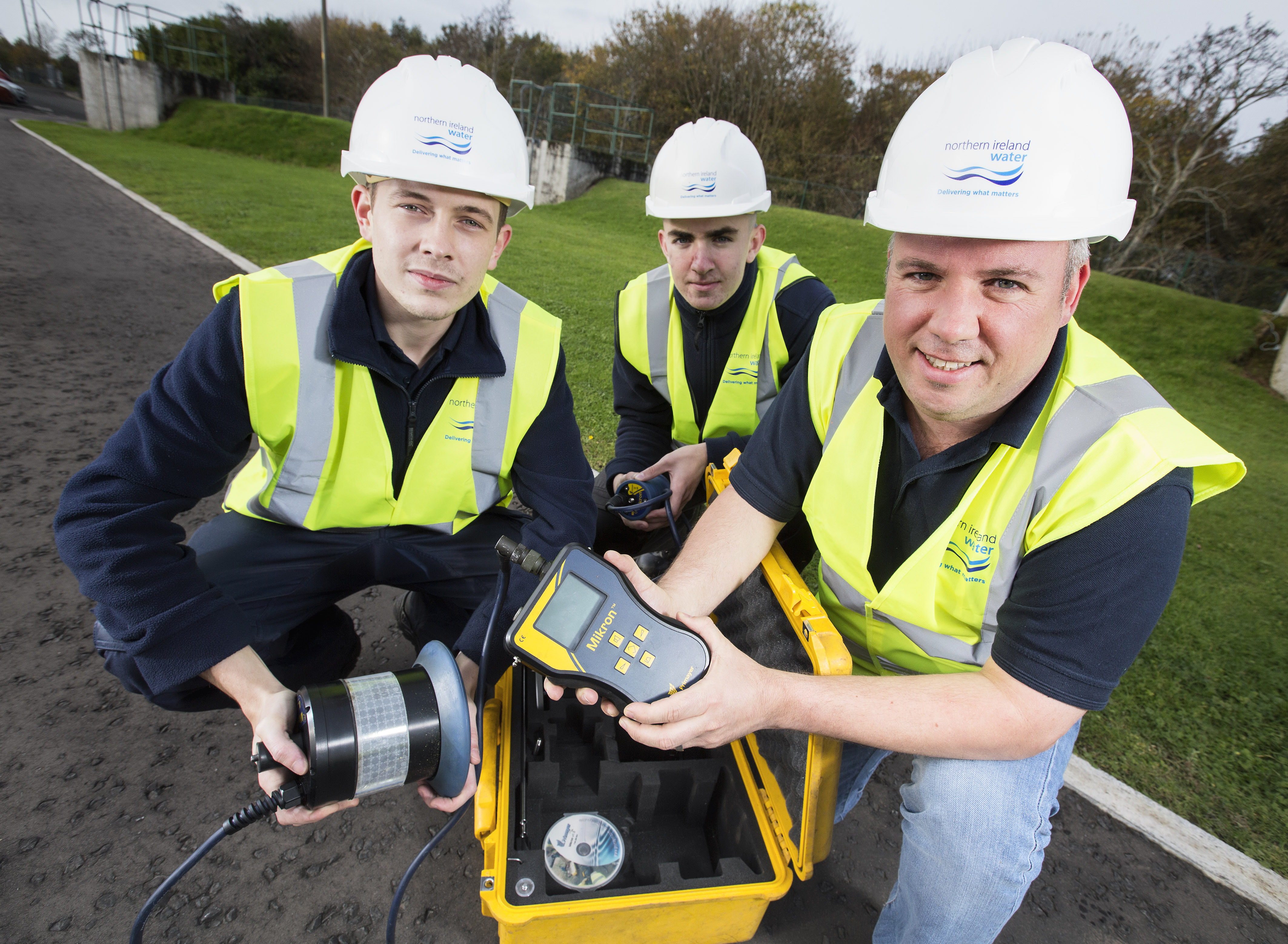 Chris Cole, Technical Learning and Development Advisor (right) shows Jack Reynolds (far left) and Toby Wright (left) how to search for leaks | NI Water News