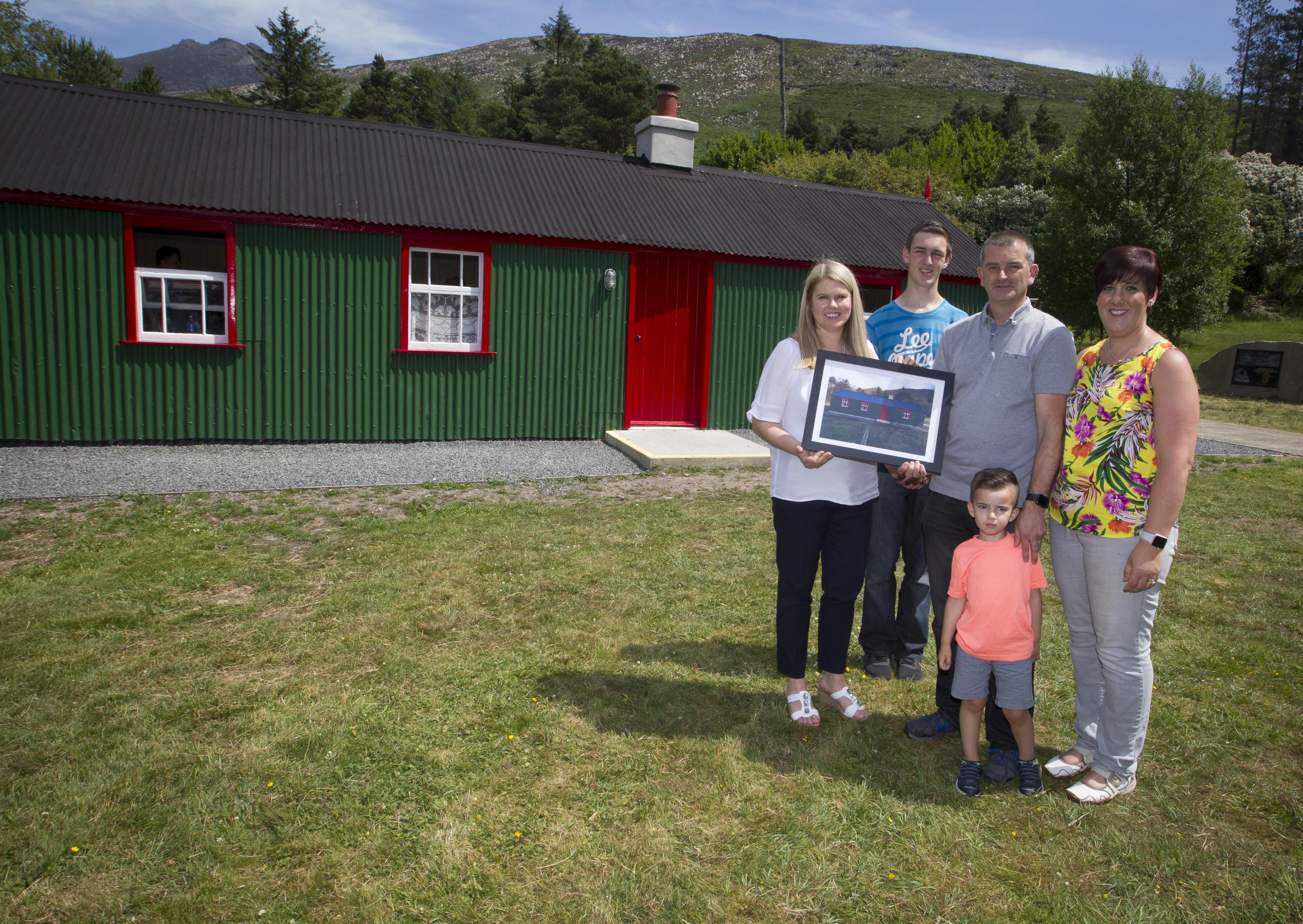 NI Water Chief Executive Sara Venning presents the Haugh family with a painting of Watertown House.  | NI Water News