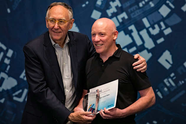 Sean O'Boyle ( NI Water Asset Information Development Manager) being presented with the award by Esri Inc President, Jack Dangermond. | NI Water News