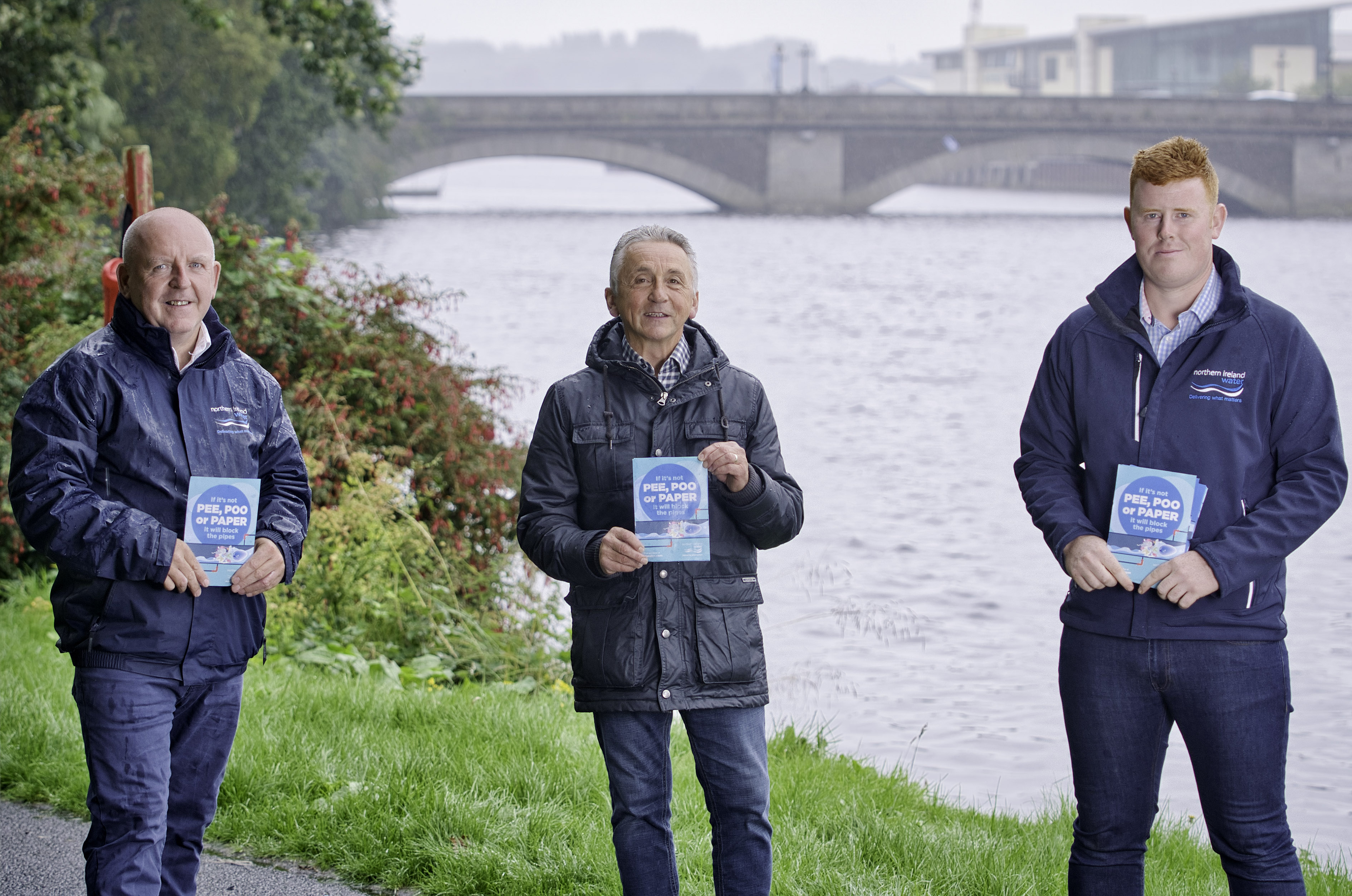 NI Water colleagues at Christie Park holding leaflets