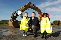 Davy McGrath NI Water Project Manager for the Greyabbey scheme waves goodbye to the diggers with primary one pupils from Greyabbey Primary School | NI Water News